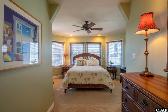 bedroom featuring recessed lighting, multiple windows, light colored carpet, and baseboards