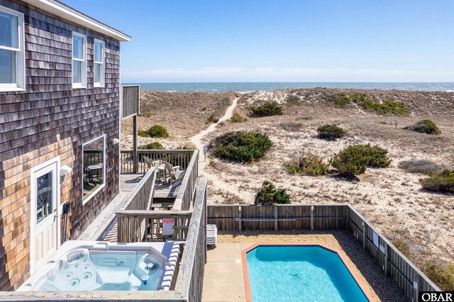 view of pool featuring a deck, a jacuzzi, fence, stairway, and a fenced in pool