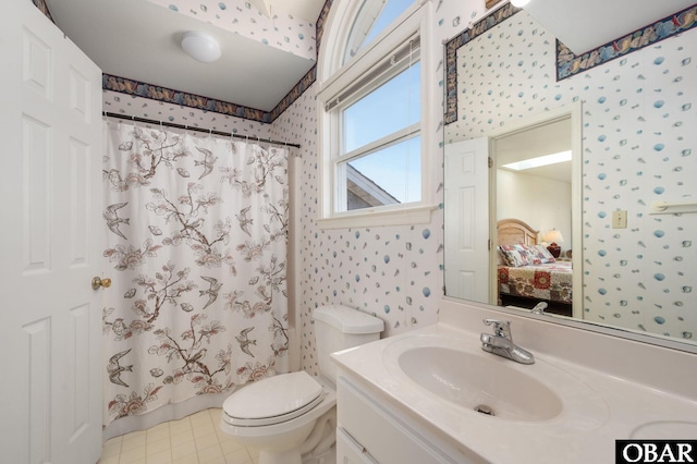 ensuite bathroom with vanity, wallpapered walls, ensuite bath, curtained shower, and toilet