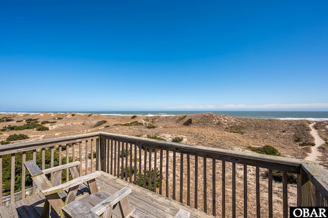 deck with a view of the beach and a water view
