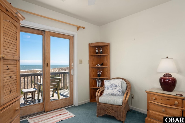 living area featuring baseboards and carpet floors