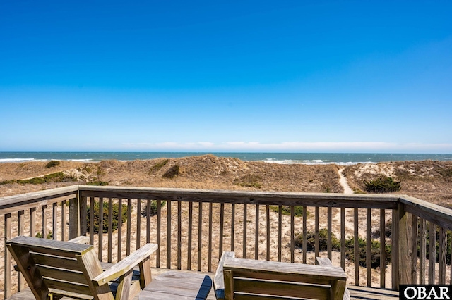 wooden terrace featuring a water view