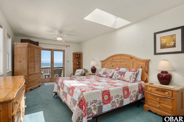 bedroom with access to exterior, carpet flooring, a skylight, and a ceiling fan