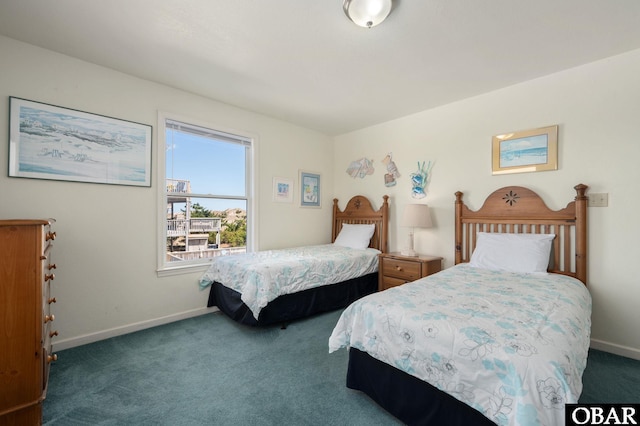 bedroom featuring carpet and baseboards
