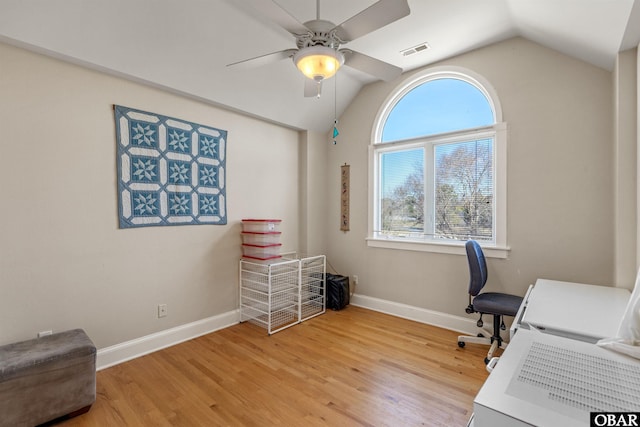 office space featuring visible vents, vaulted ceiling, a ceiling fan, and light wood finished floors