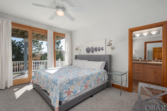 bedroom with light carpet, access to outside, ceiling fan, and ensuite bath