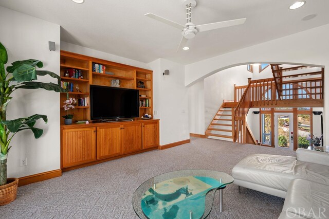 living area with a ceiling fan, arched walkways, light carpet, and recessed lighting