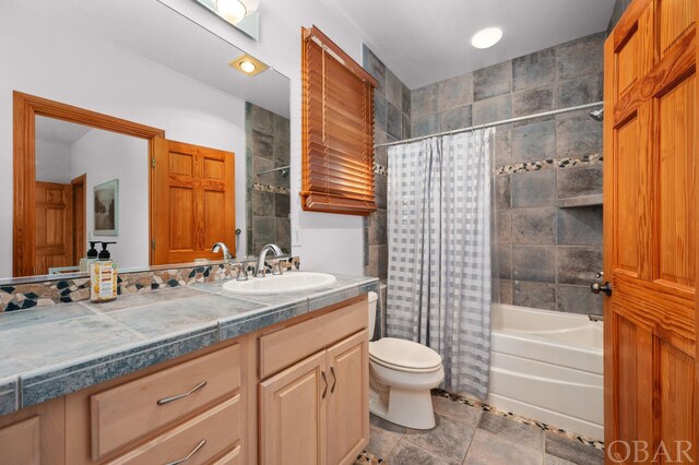 bathroom featuring toilet, shower / tub combo, and vanity