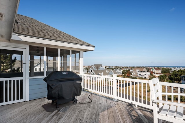 deck with a residential view, a sunroom, and grilling area