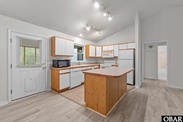 106 Mybet Ct Lot 97, Kill Devil Hills, NC 27948 - kitchen featuring white appliances, rail lighting, light wood-type flooring, white cabinets, and a kitchen island