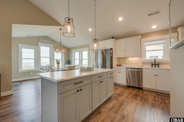 27197 Black Dog Ln Lot 9, Salvo, NC 27972 - kitchen featuring appliances with stainless steel finishes, lofted ceiling, dark wood finished floors, light countertops, and white cabinetry