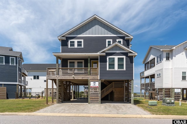 27197 Black Dog Ln Lot 9, Salvo, NC 27972 - coastal home with a carport, a porch, stairway, board and batten siding, and driveway
