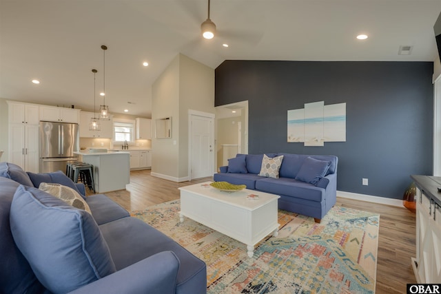 27197 Black Dog Ln Lot 9, Salvo, NC 27972 - living room featuring a ceiling fan, light wood-style floors, high vaulted ceiling, and recessed lighting