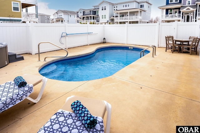 view of swimming pool featuring a patio, a fenced backyard, and a residential view