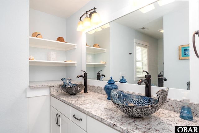 full bathroom featuring built in features, visible vents, and vanity