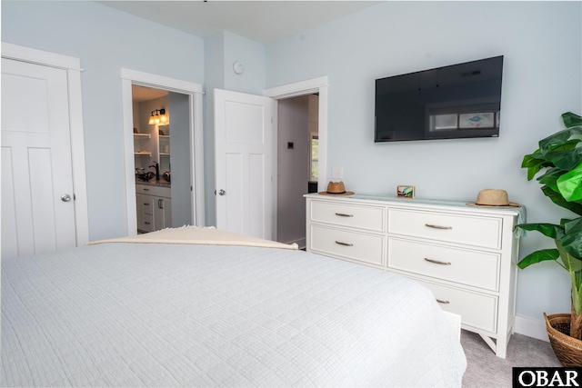 bedroom with light carpet and ensuite bathroom