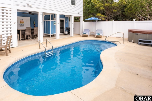 view of pool featuring area for grilling, a patio, fence, a fenced in pool, and a hot tub