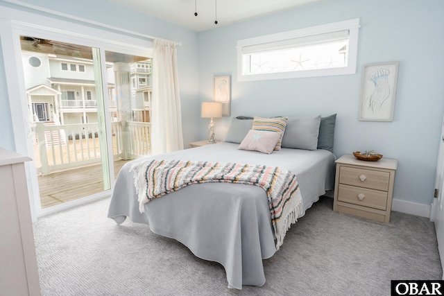 bedroom featuring carpet flooring, baseboards, and access to outside