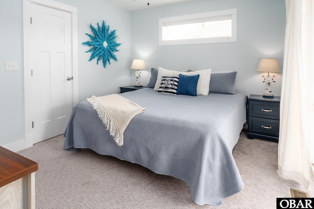 bedroom with visible vents and carpet floors