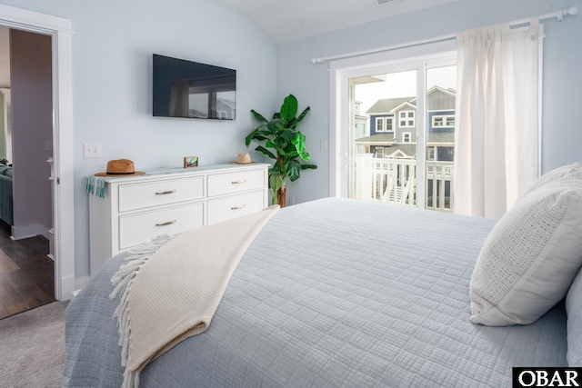 bedroom with lofted ceiling and carpet floors