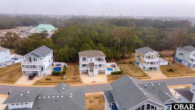 birds eye view of property with a view of trees