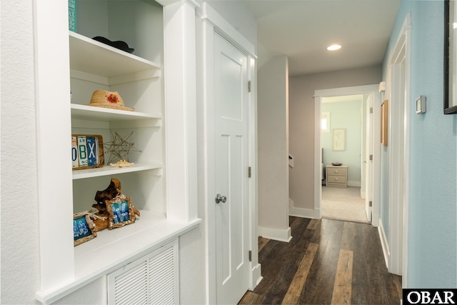 hallway featuring recessed lighting, baseboards, built in features, and dark wood-style floors