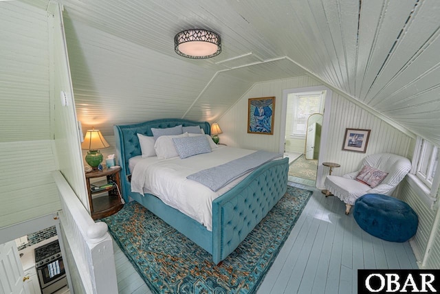 807 S St Lot 11, Manteo, NC 27954 - bedroom featuring wood-type flooring, wooden walls, and vaulted ceiling