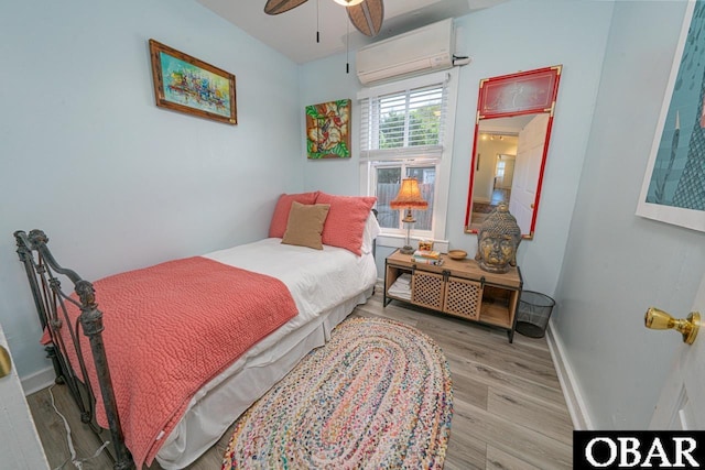 807 S St Lot 11, Manteo, NC 27954 - bedroom with ceiling fan, baseboards, a wall mounted AC, and wood finished floors