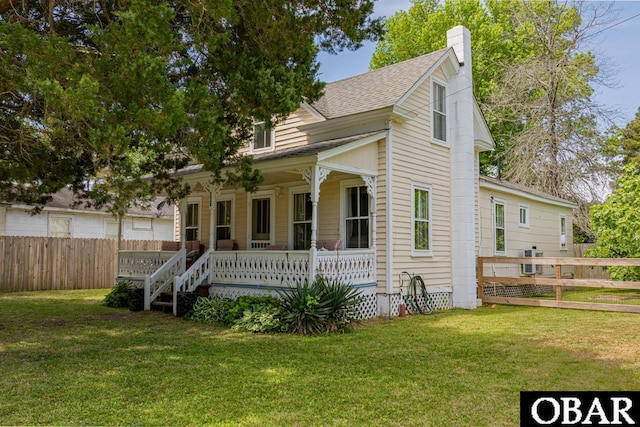 807 S St Lot 11, Manteo, NC 27954 - bungalow with a porch, a front lawn, fence, and a chimney