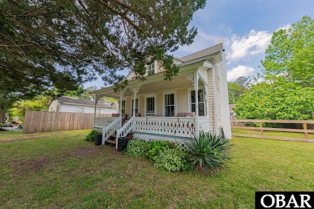 807 S St Lot 11, Manteo, NC 27954 - view of front of property featuring a front lawn, fence, and covered porch