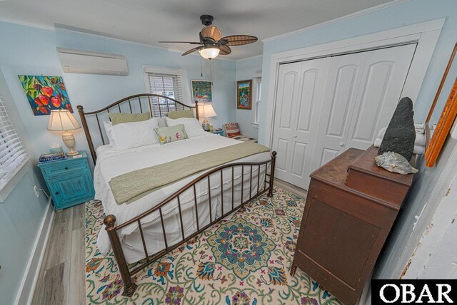 807 S St Lot 11, Manteo, NC 27954 - bedroom with ceiling fan, an AC wall unit, wood finished floors, ornamental molding, and a closet