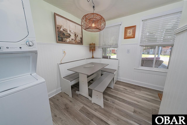 807 S St Lot 11, Manteo, NC 27954 - dining room featuring stacked washer / drying machine, wainscoting, wood finished floors, and a wealth of natural light