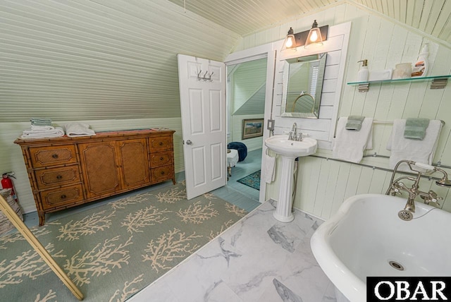 807 S St Lot 11, Manteo, NC 27954 - bathroom featuring wooden walls, a sink, a soaking tub, and lofted ceiling