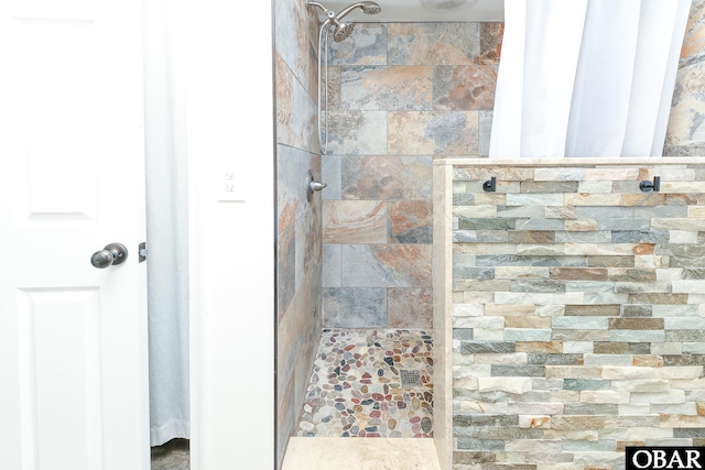 bathroom with tiled shower