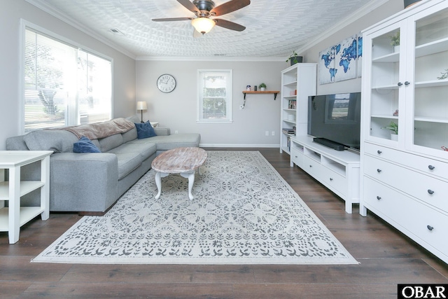 living room with baseboards, a ceiling fan, dark wood-type flooring, and crown molding