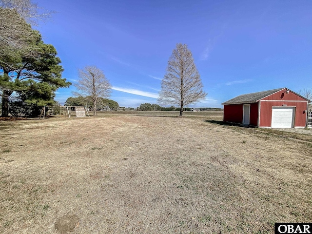 view of yard featuring an outdoor structure and a rural view