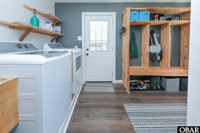 laundry area with washer and dryer, laundry area, baseboards, and dark wood-style flooring