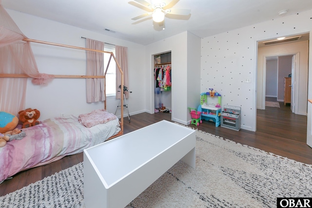 bedroom with dark wood-type flooring, visible vents, and baseboards