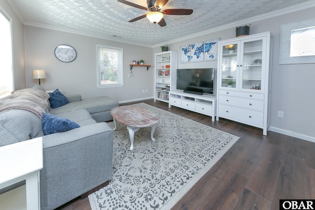 living area featuring dark wood-style floors, baseboards, ornamental molding, and a ceiling fan