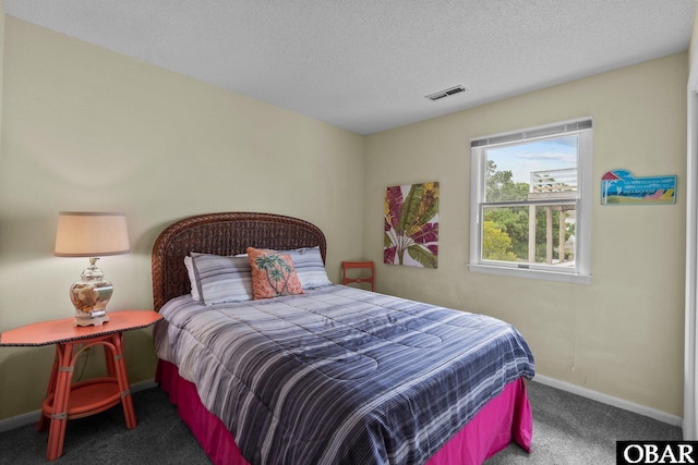 bedroom with visible vents, a textured ceiling, baseboards, and carpet floors