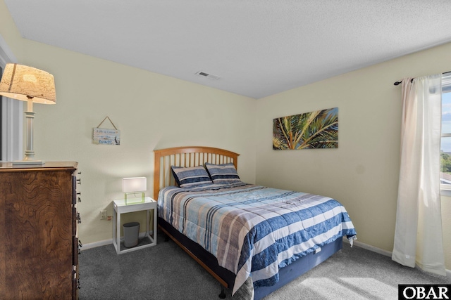 carpeted bedroom featuring baseboards and visible vents