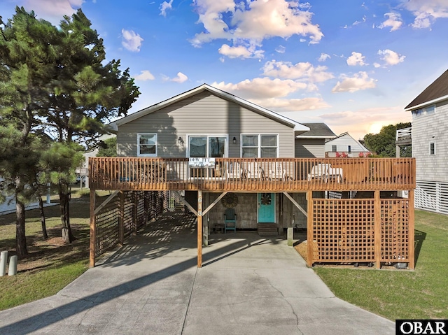 1613 N Croatan Hwy Lot # 23, Kill Devil Hills, NC 27948 - view of front of home featuring a deck, concrete driveway, and a carport