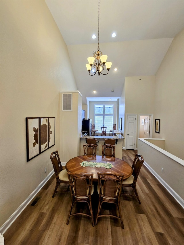1111 Cambridge Rd Unit 308B, Kill Devil Hills, NC 27948 - dining space featuring dark wood finished floors, baseboards, a chandelier, lofted ceiling, and recessed lighting