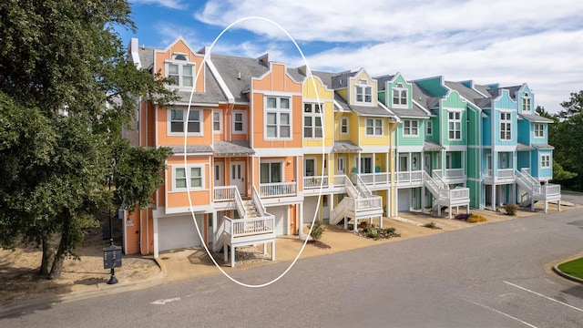 1111 Cambridge Rd Unit 308B, Kill Devil Hills, NC 27948 - view of property with a residential view, an attached garage, stairs, and driveway