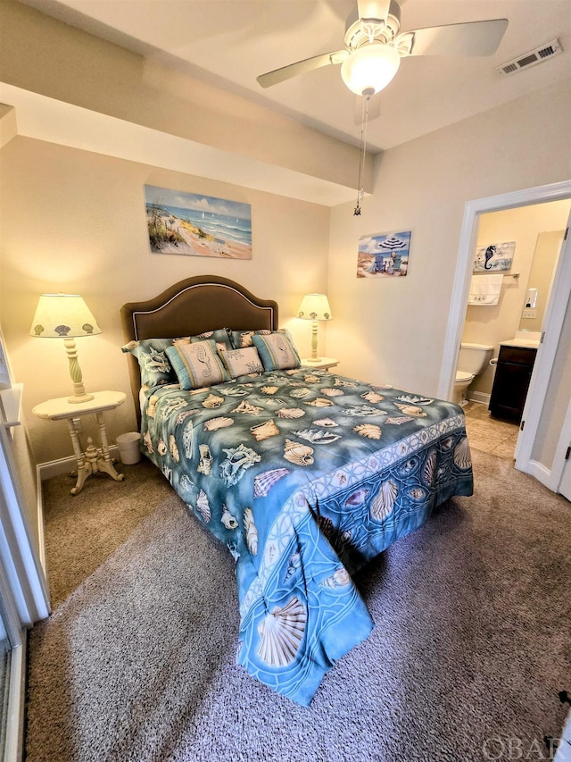 carpeted bedroom featuring a ceiling fan, visible vents, connected bathroom, and baseboards