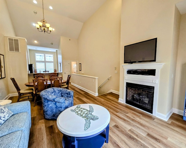 1111 Cambridge Rd Unit 308B, Kill Devil Hills, NC 27948 - living room featuring wood finished floors, a chandelier, high vaulted ceiling, baseboards, and recessed lighting