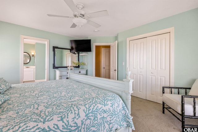 bedroom with light carpet, ensuite bath, ceiling fan, and a closet