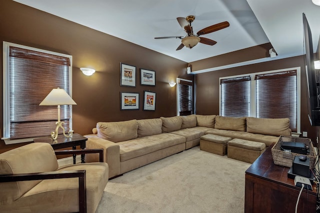 living area featuring a ceiling fan and light colored carpet