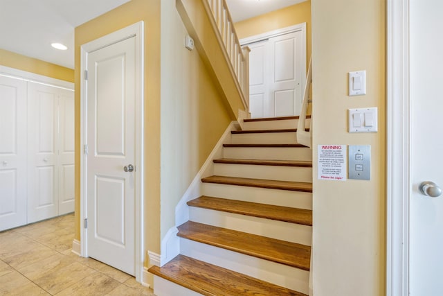 staircase with baseboards and recessed lighting