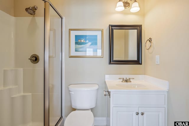 full bathroom with a stall shower, vanity, and toilet